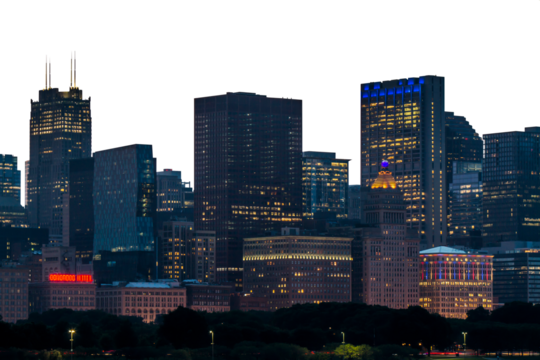 Chicago skyline at night with illuminated buildings against a white backdrop, showcasing the city's architectural beauty. Urban cityscape concept