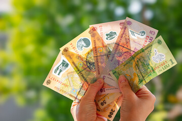 Fan of Romanian Lei banknotes in hand