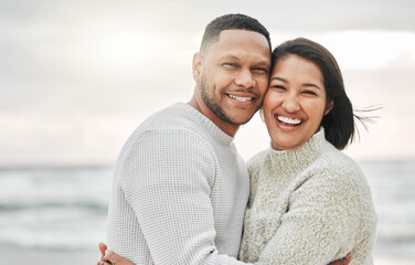 Obraz premium Travel, couple and portrait with hug on beach for love, romance or happy on holiday in Thailand. People, face and smile with embrace for bonding, affection or anniversary vacation by ocean on weekend