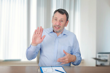 A life coach in a blue shirt gestures, promoting self-help materials online, promising secrets to a successful life for a fee.