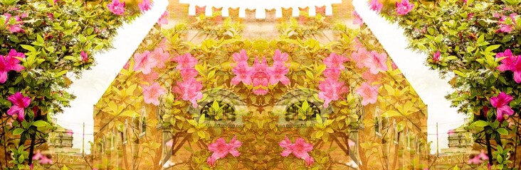 Flores cor de rosa sobre construção de prédio de paredes e torres de tijolos. 