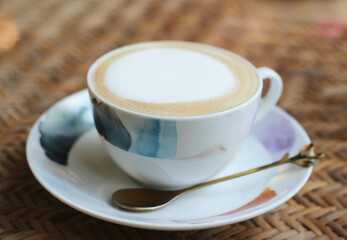 Hot cappuccino latte coffee cup on a table in a coffee shop