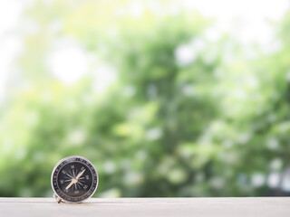 Close up compass on table in the sunset time. The concept of world tourism day, Searching the right directions and Travel