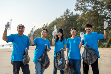 Group teamwork volunteer pick up the plastic bottle on the beach. People male and female Volunteer with garbage bags clean the trash on the beach make the sea beautiful. World environment day CSR.