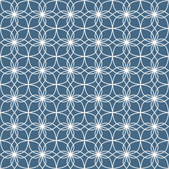 Seamless pattern of floral ornament shapes, with white curved lines on a denim blue background. Suitable for various decorative purposes with a natural theme.