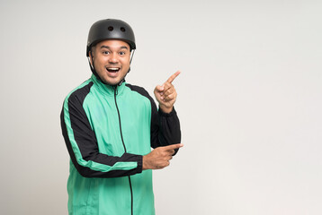 Young asian rider wearing green jacket uniform and bike helmet standing various action on isolated white background. Male delivery service worker. Delivery courier and shipping food service.