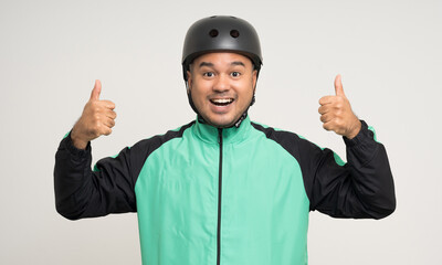 Young asian rider wearing green jacket uniform and bike helmet standing various action on isolated white background. Male delivery service worker. Delivery courier and shipping food service.