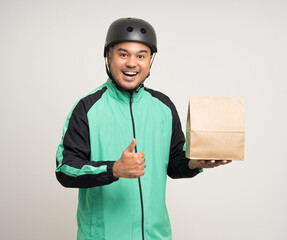 Young asian rider wearing green jacket uniform and bike helmet various action holding food paper bag delivery to customer. Male delivery service worker. Courier and shipping food service.
