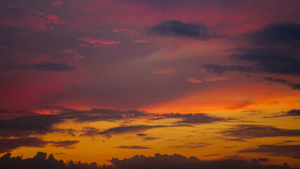 Fototapeta premium Bright yellow red sky and clouds at sunset, background