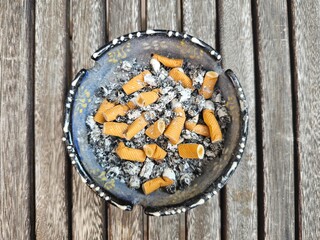 Ashtray full of cigarettes butts close-up