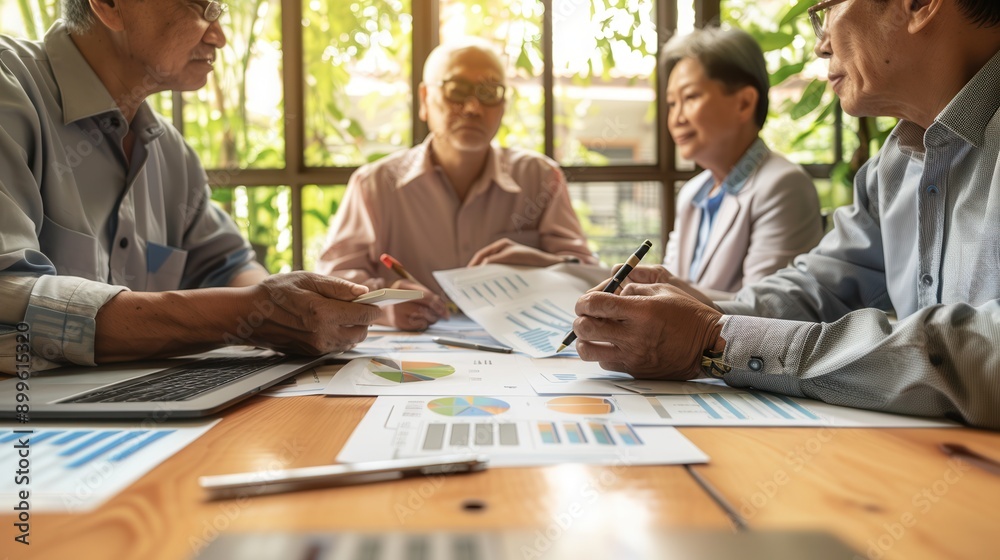 Aufkleber a group of elderly individuals collaborates on business strategies while reviewing charts and graphs