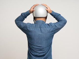 Young rider man wearing safety helmet before riding the motorcycle. Safety ride.