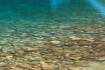 Fototapeta premium Transparent clean blue water in a mountain lake. Water background. Black Lake below Mount Rysy, Tatra Mountains