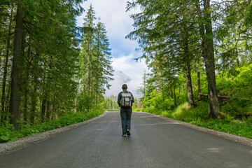 A man on a mountain road. Hiking in the mountains in summer. Road to Morskie Oko. Tatras © bykot