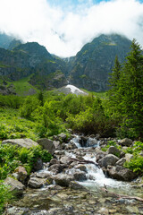 Morskie Oko, or Eye of the Sea. View of the Czarnostawianska Siklawa waterfall. Summer landscape in the Tatras