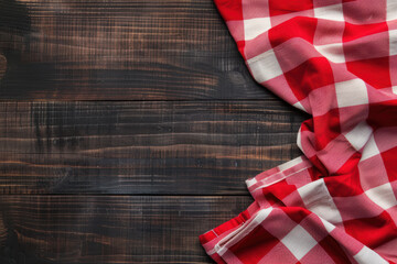 Red and white checkered cloth on rustic dark wooden table creating a cozy kitchen or picnic scene ideal for culinary or homestyle themed projects.