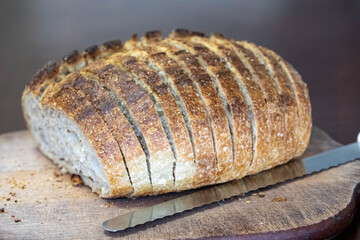 Sliced ​​artisanal rustic bread on a wooden surface