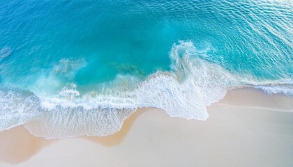 Obraz premium Beautiful tropical summer beach, top view of white sand and blue sea waves, nature background, vacation in paradise concept for tourism, vivid colorful.