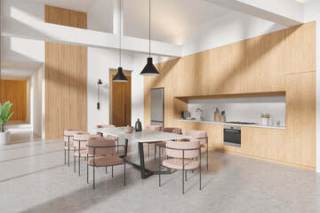 Stylish home kitchen interior with dining table and cooking cabinet, refrigerator