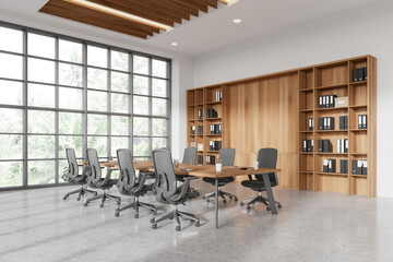 Stylish office meeting room interior with table and armchairs, shelf and window