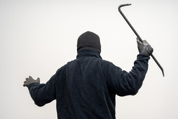 Thief in uniform black jacket various pose on isolated background. The Robber terrorism criminal escapes with balaclava and crowbar entering a house for stealing Housebreak