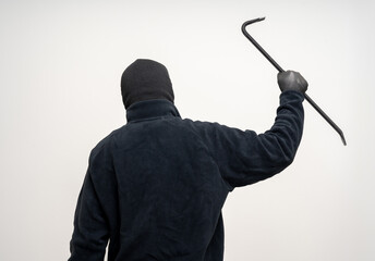 Thief in uniform black jacket various pose on isolated background. The Robber terrorism criminal escapes with balaclava and crowbar entering a house for stealing Housebreak