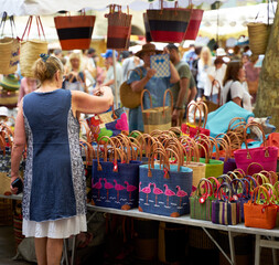 People looking at goods at the Uzès market, one of the most beautiful in France