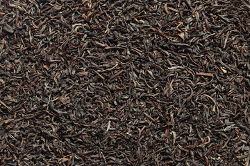 Long black tea, texture. Top view of dried tea leaves. Tea composition. Ingredients for a hot...