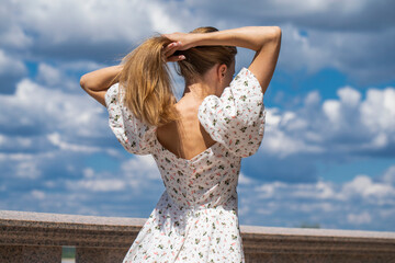 Blonde female hair back, summer outdoors