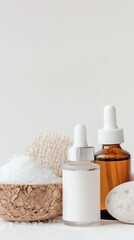 Skincare cosmetic products including a brown bottle, white bottle with dropper, placed next to a loofah and bath salt on a minimal background.