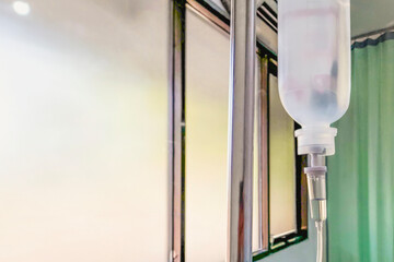 hanging pillar and saline solution infusion bag in emergency room at hospital
