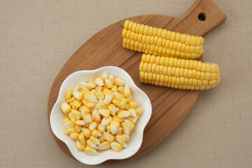 Raw fresh corn seeds on white bowl
