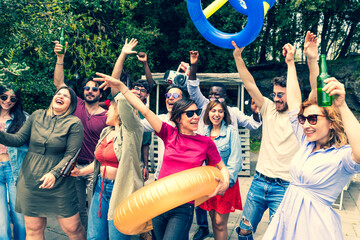Multiracial friends dancing in pool terrace with boom box – multiethnic young people having fun together – diverse group person dance in villa pool party 