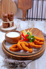 Crunchy Fried Battered onion rings on black plate
