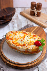 bechamel boiling in a oven. Close up view of cheese bubbles. Traditional greek dish
