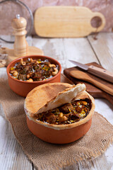 Baked meat in a clay pot, or a traditional pot dish, a stew with vegetables and meat cooked in the oven. Turkish and balkan or oriental food platter, flat lay
