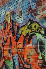 Fototapeta premium Vibrant Graffiti Mural on Brick Wall in Urban Alleyway During Daylight