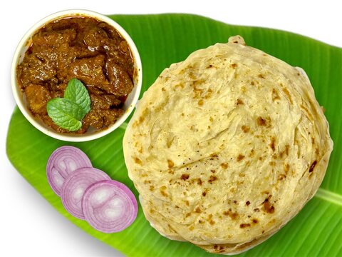 Kerala delicious food porotta and beef roast on banana leaf 