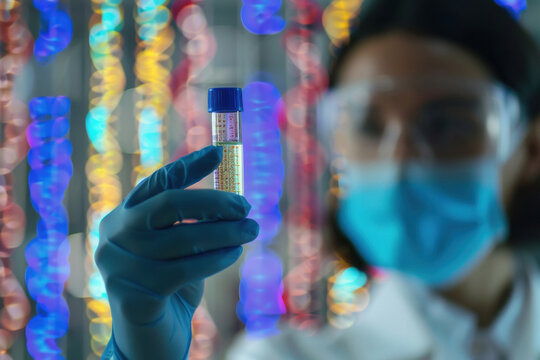Genetics research. Scientist holding vial with liquid and illustration of DNA structure