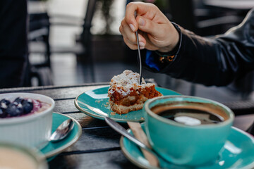 Cup of coffee and cake in cafe - delicious apple pie tasting, hand close up