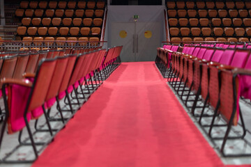 Several wooden and red velvet chairs from the concert hall at Coliseu dos recreios in Lisbon