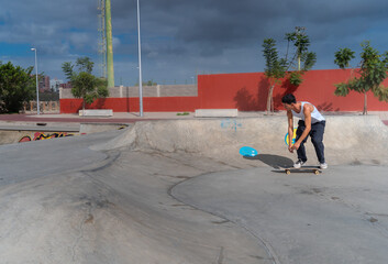 young man skates in a skate park