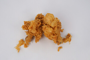 Golden brown fried chicken on white background. Fried chicken isolated over white.  Fried chicken isolated on white background. Crispy fried chicken pieces in mid-air with crumbs scattering isolated