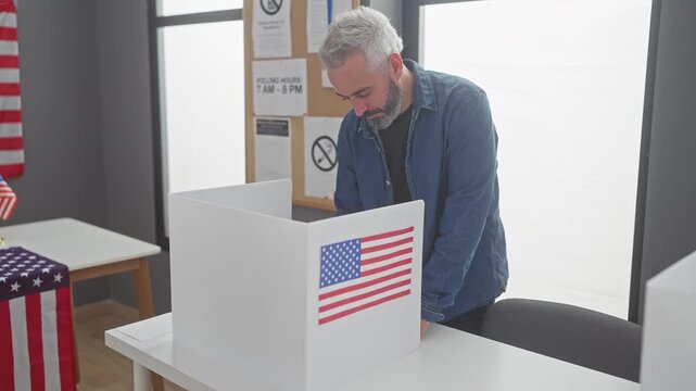 Mature man voting in american election, indoor with usa flag