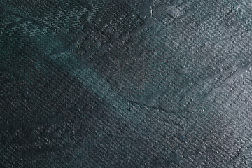 Superficie con texture materica molto irregolare dipinta di colore grigio-nero con striature verde...