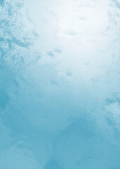 Sunny day with blue sky and clouds reflecting on water, top view