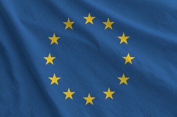 European union flag depicted on folded wavy fabric of old cloth close up