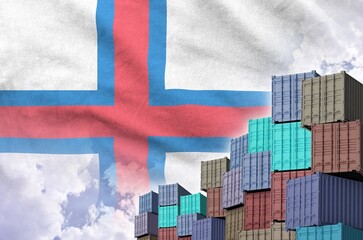 Faroe islands flag and big stack of shipping cargo containers in docks with sky background close up