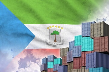 Equatorial Guinea flag and big stack of shipping cargo containers in docks with sky background close up