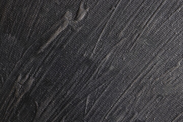 Superficie con texture materica molto irregolare dipinta di colore grigio-nero; spazio per testo